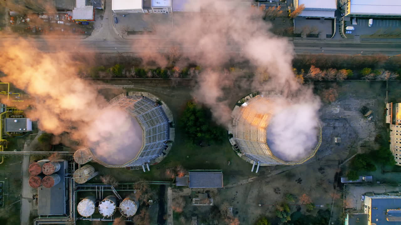 Aerial drone view of thermoelectric tower with white smoke in winter