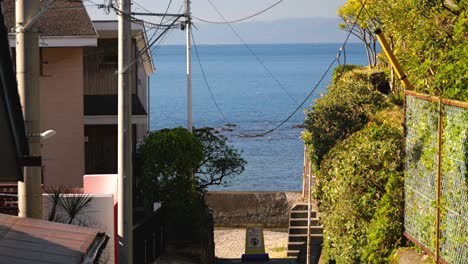 typical japanese surfer town with small road leading to ocean