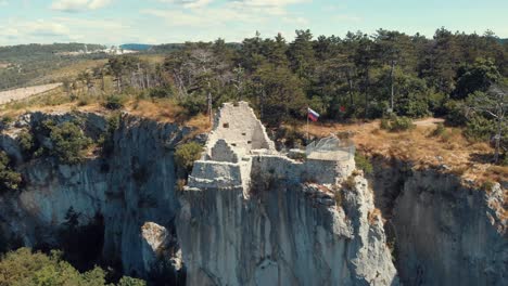 castle on its own rock connected to the land with a bridge