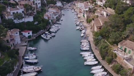 panoramic shot of port de cala figuera mallorca with docked yachts, aerial