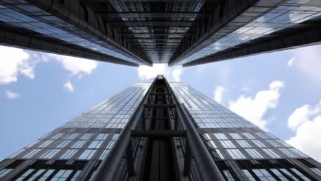 a captivating perspective of modern skyscrapers soaring toward the sky, showcasing their impressive glass facades under a beautifully cloudy sky