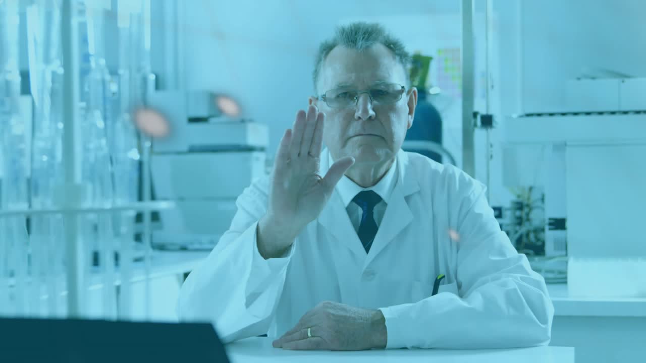 Senior male researcher responding to overlays, gesturing in laboratory, forming charts for analysis