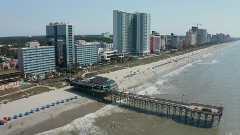 Descending-aerial-of-pier-at-Myrtle-Beach,-SC,-USA