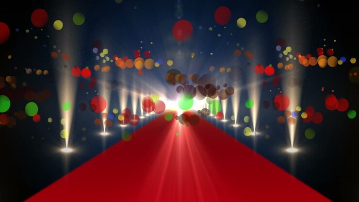 Animazione di puntini multicolore che cadono su tappeto rosso e luci