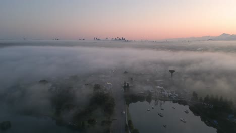 Nebelige-Sydney-Skyline-Bei-Sonnenaufgang,-Schöner-Rückwärtsflug-über-Die-Prinzessin-autobahn-Mit-Verkehr-Am-Morgen