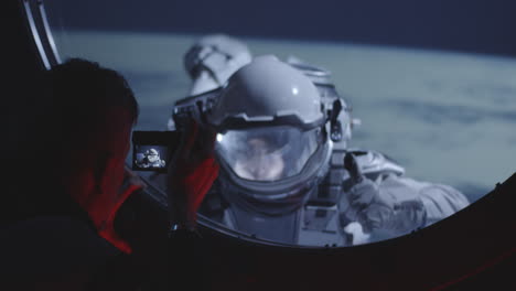 astronaut spacewalk viewed through a spacecraft window