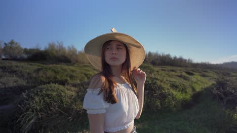 woman standing on verdant grassy countryside