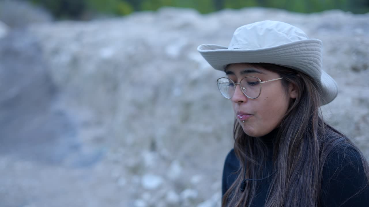Woman in a hat and glasses, outdoors