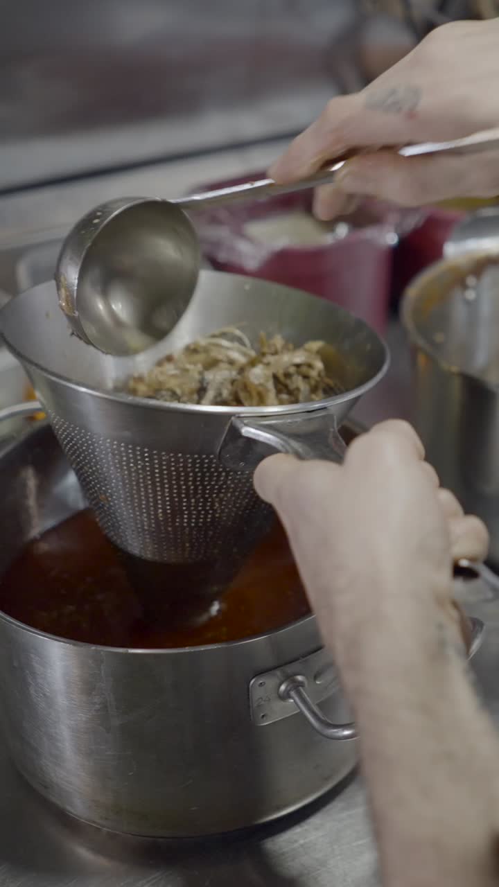 Chef Straining Ingredients in a Commercial Kitchen