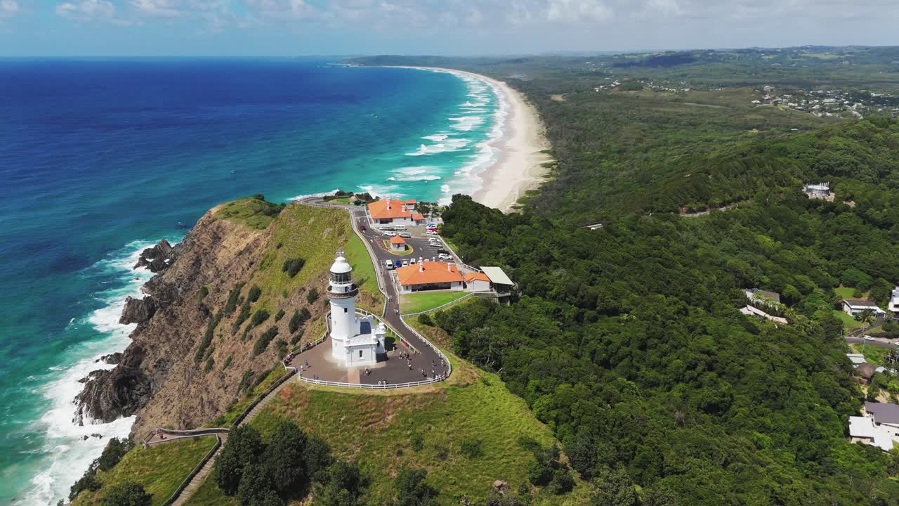 Aerial: Cape Byron Light during the day with sand beach and coastline in Cape Byron, New South Wales, Australia, orbit drone shot