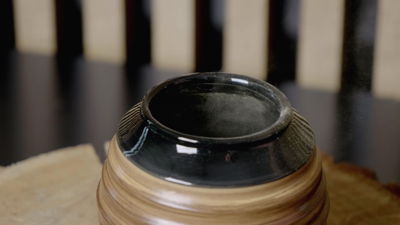 Yerba mate, pouring the dry leaves into a gourd with a wooden spoon