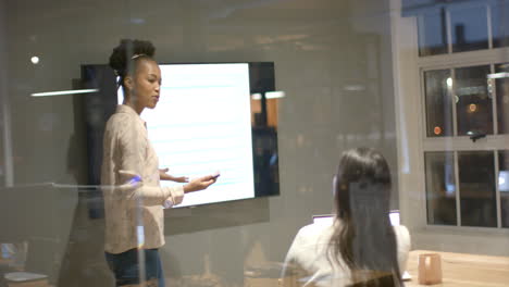 young african american woman presents in a modern office setting