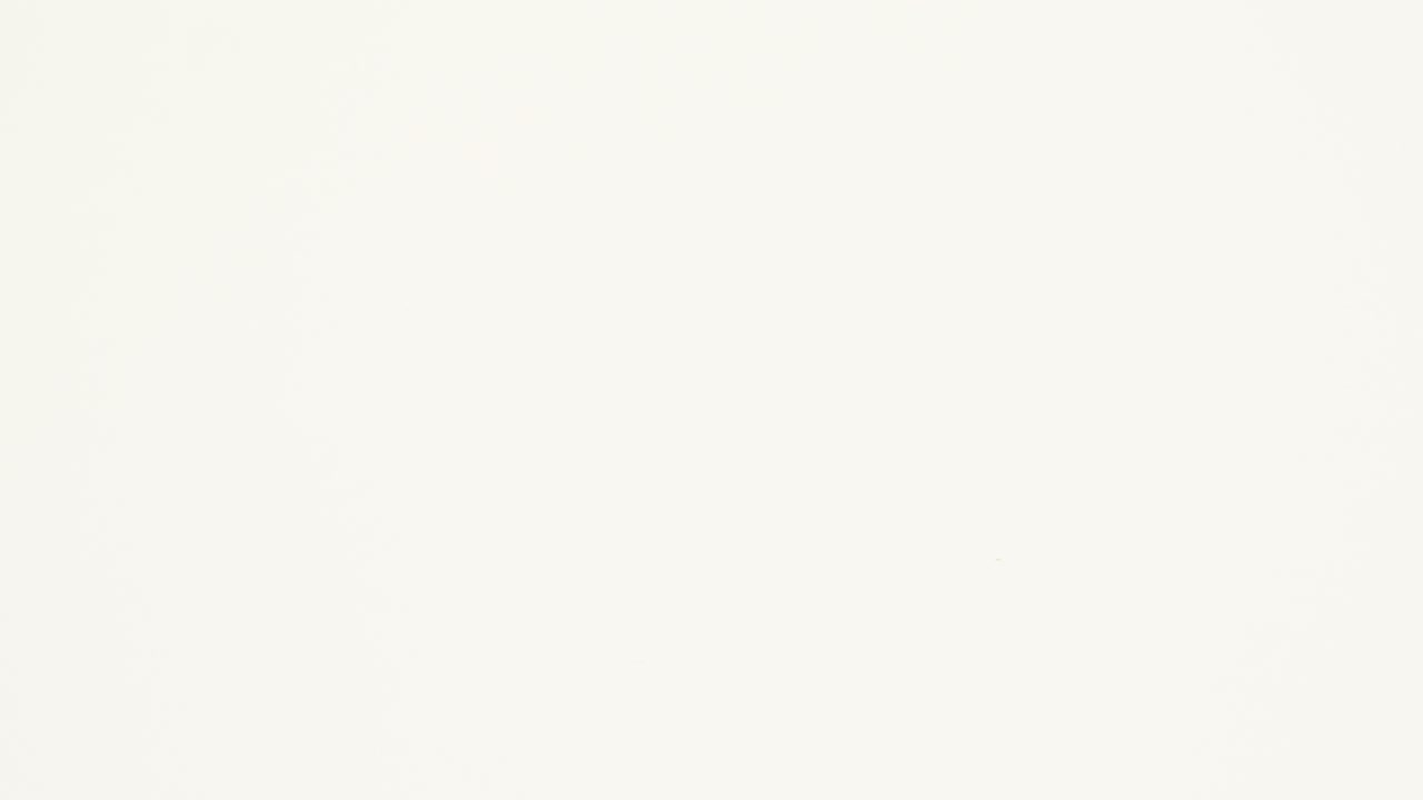 Green crumpled paper unfolds then refolds on beige in stop motion transition