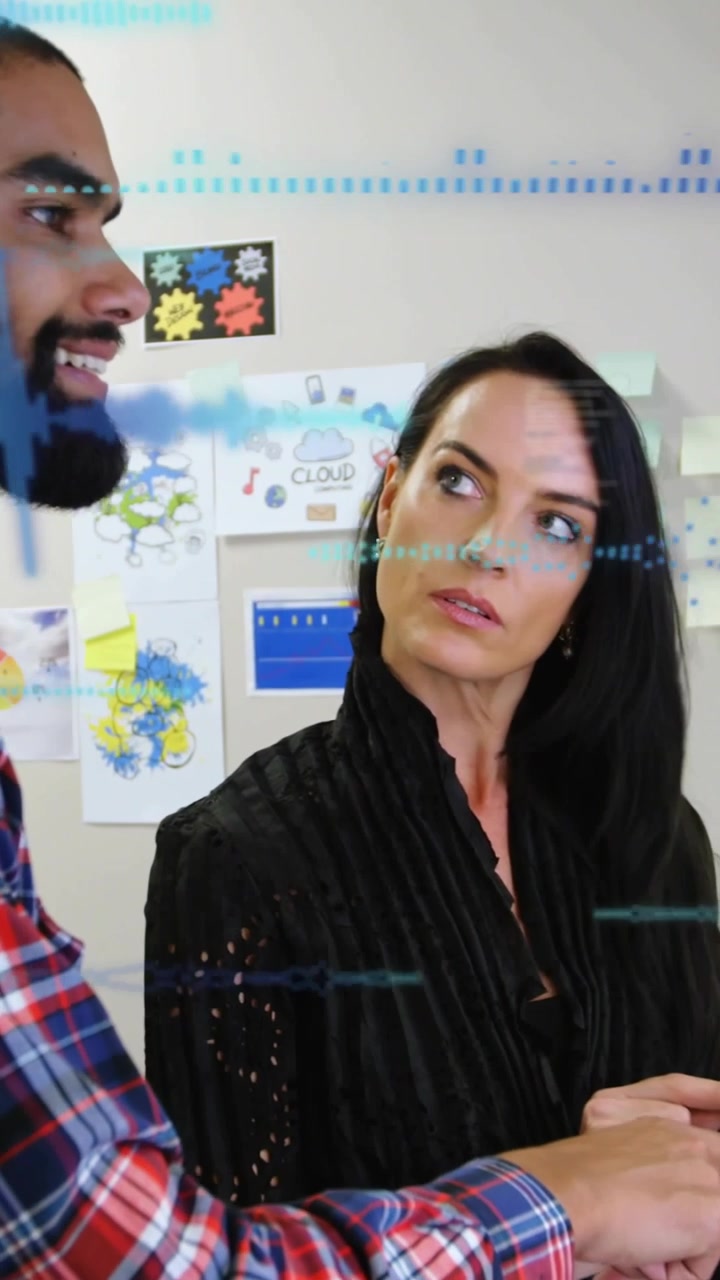 Vertical video: Man showing phone, causing HUD overlays, woman studying chart for business review