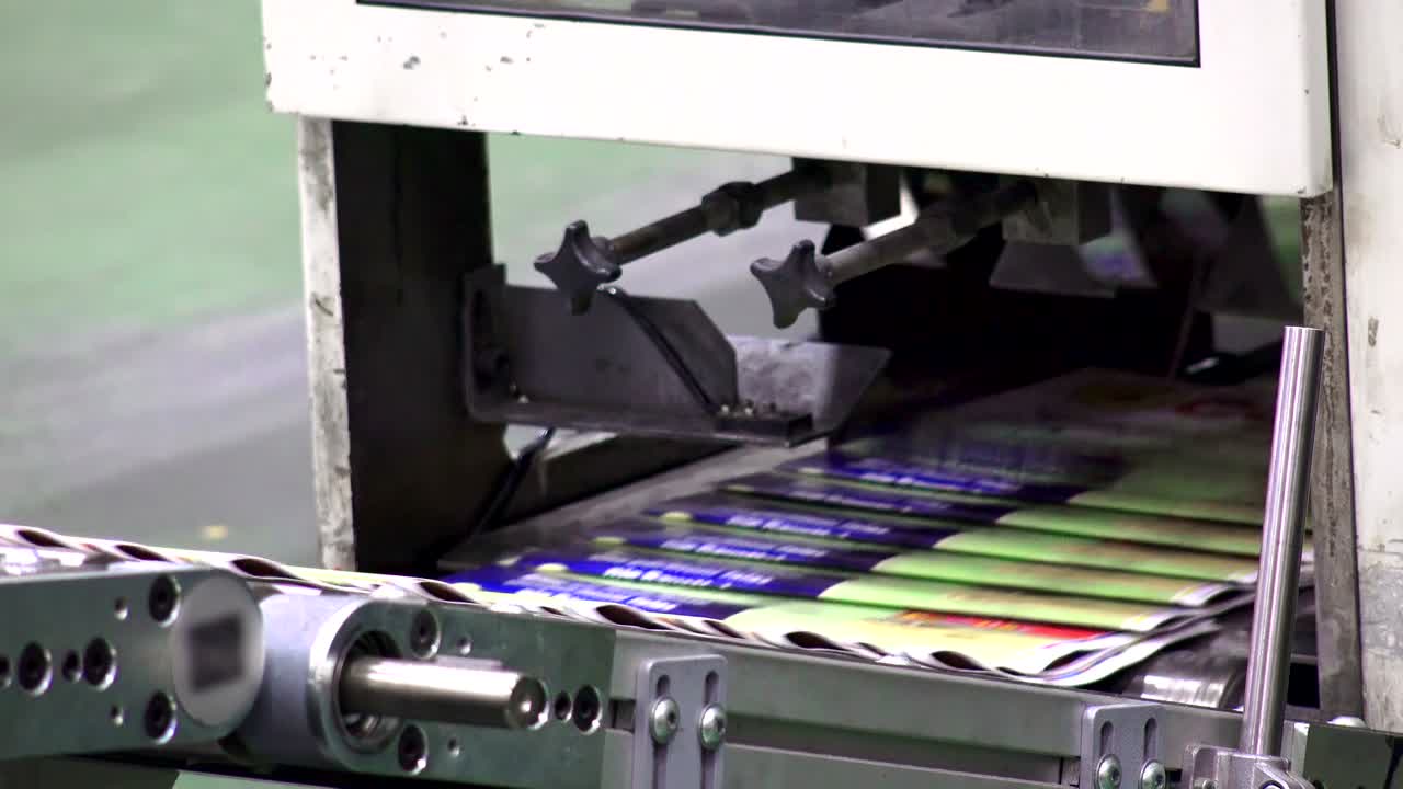 print plant factory, magazine transports on conveyor belt line after printing units and folder, LOOP BACKGROUND