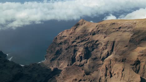 mesmerizing revealing shot of rolling clouds with mountain silhouette in background