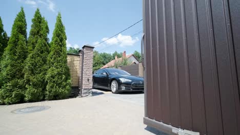 man in the car opening automatic property gate with remote controller