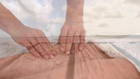 Animation-of-hands-of-caucasian-woman-doing-massage-over-seascape