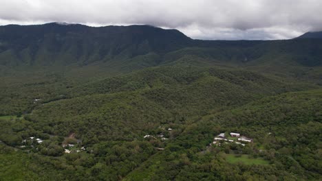 Aerial-View-of-Rainforest,-Hills-and-Homes-on-East-Coast-of-Australia,-Scenic-Landscape-on-Cloudy-Day