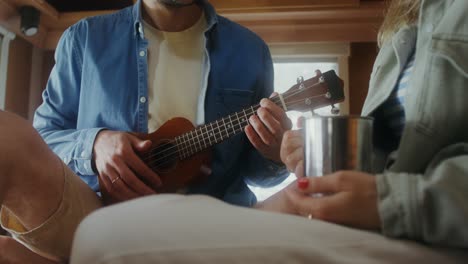 couple playing ukulele in rv