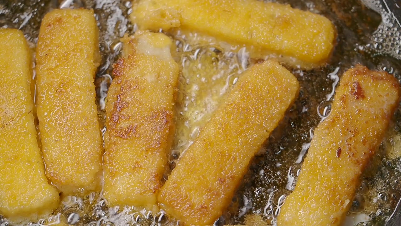 Golden Brown Fish Sticks Frying in Hot Oil