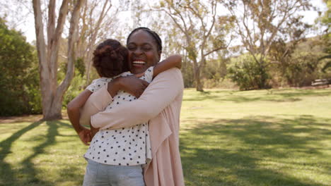 African-American-grandma-lifting-her-granddaughter-in-park