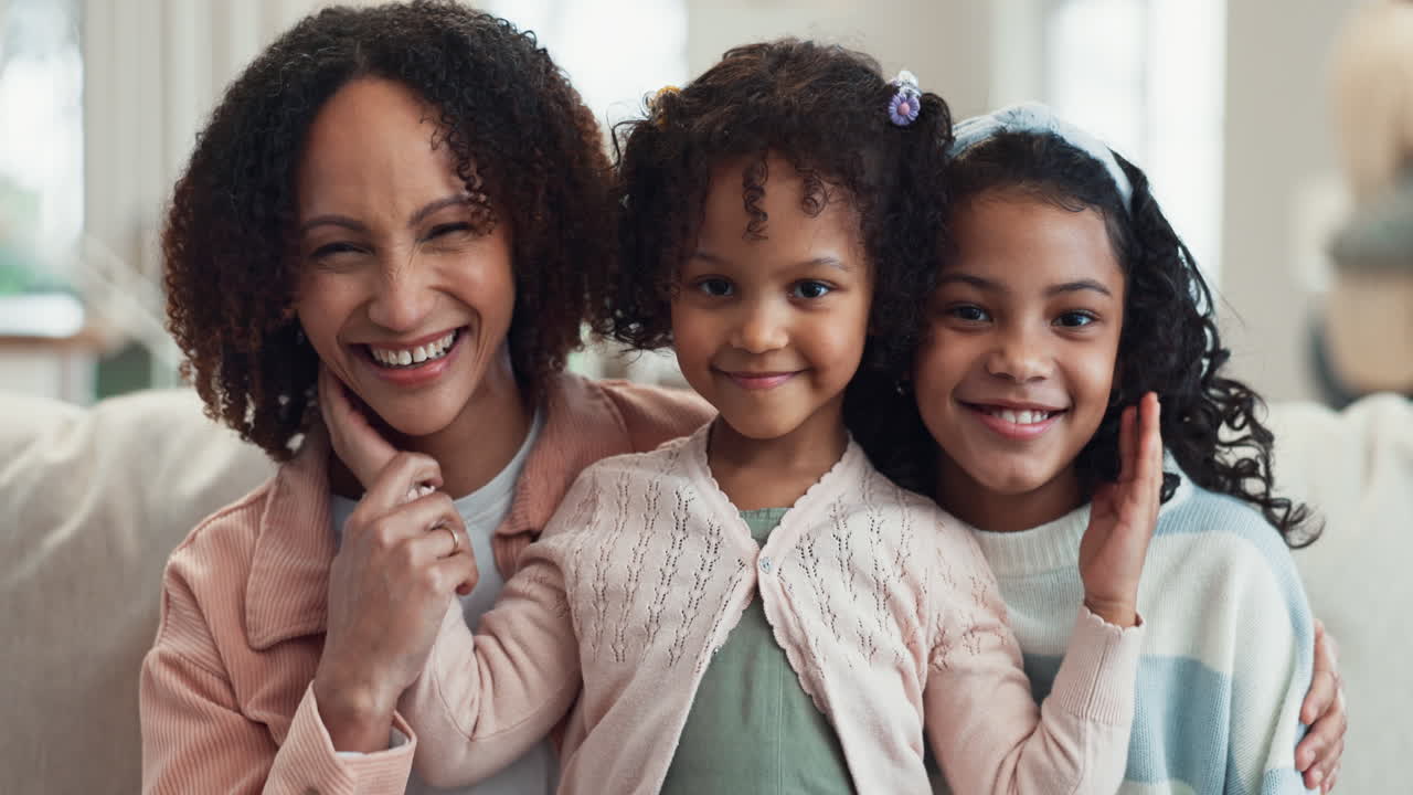 A mother and her two daughters smile for the camera.
