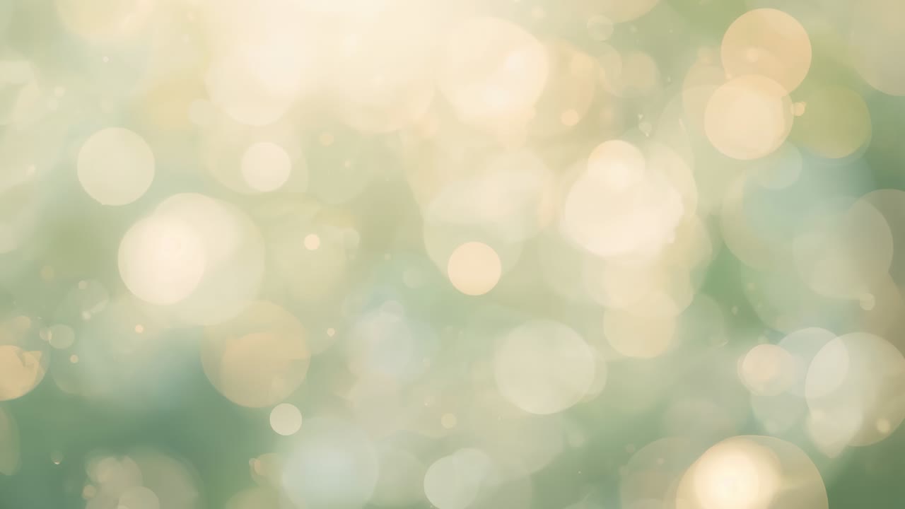 Responding to shift, abstract bokeh field drifting in frame showing circular orbs over teal wash