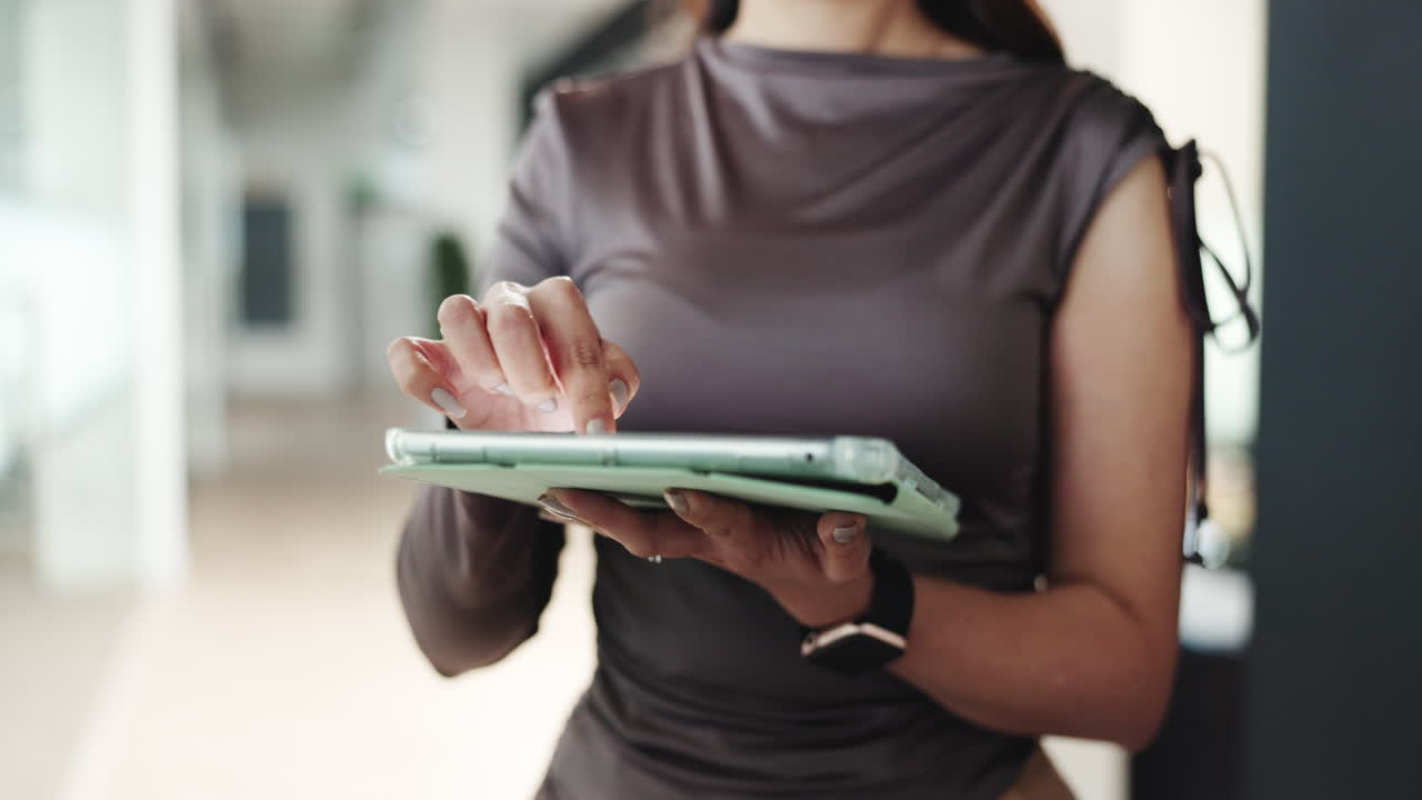 Close-up of Woman's Hands Using Digital Tablet in Office