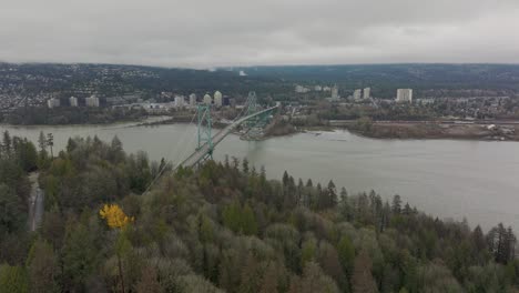 Drohnen-Luftaufnahme,-Die-In-Richtung-Nord-Vancouver-Stadtbild-Fliegt-Und-Die-Lions-Gate-Bridge-In-4k-Passiert