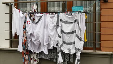 clothes drying on a clothesline outside a window