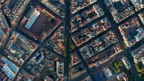 Aerial-birds-eye-overhead-top-down-panning-view-of-town-development-from-height.-Blocks-of-building-divided-by-busy-streets.