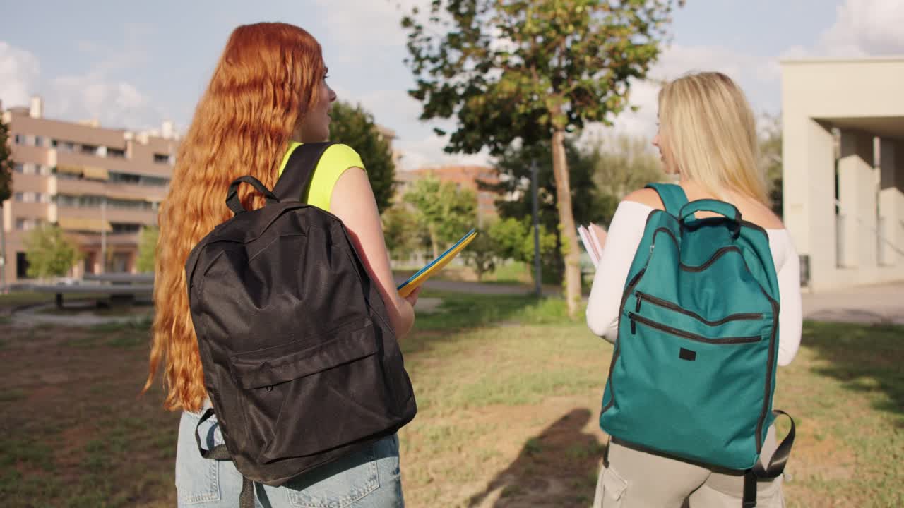 Two students walking on campus