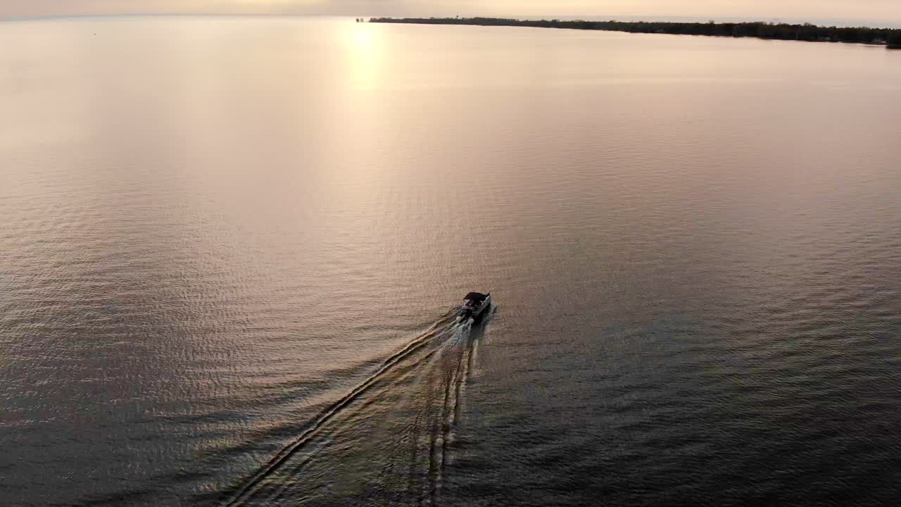 Filmato drone di una barca da diporto che naviga sul Lago Huron al tramonto in Michigan