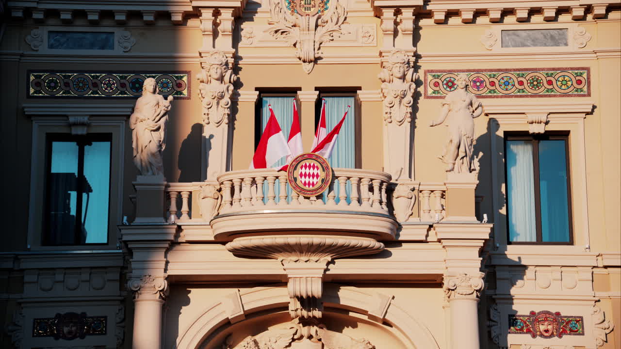 Monte Carlo, Monaco - October 24, 2024: The coat of arms of Monaco and multiple flags waving on the Monte Carlo Casino