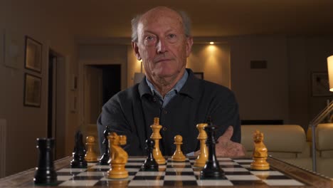 a man puts his opponent into check during a chess match