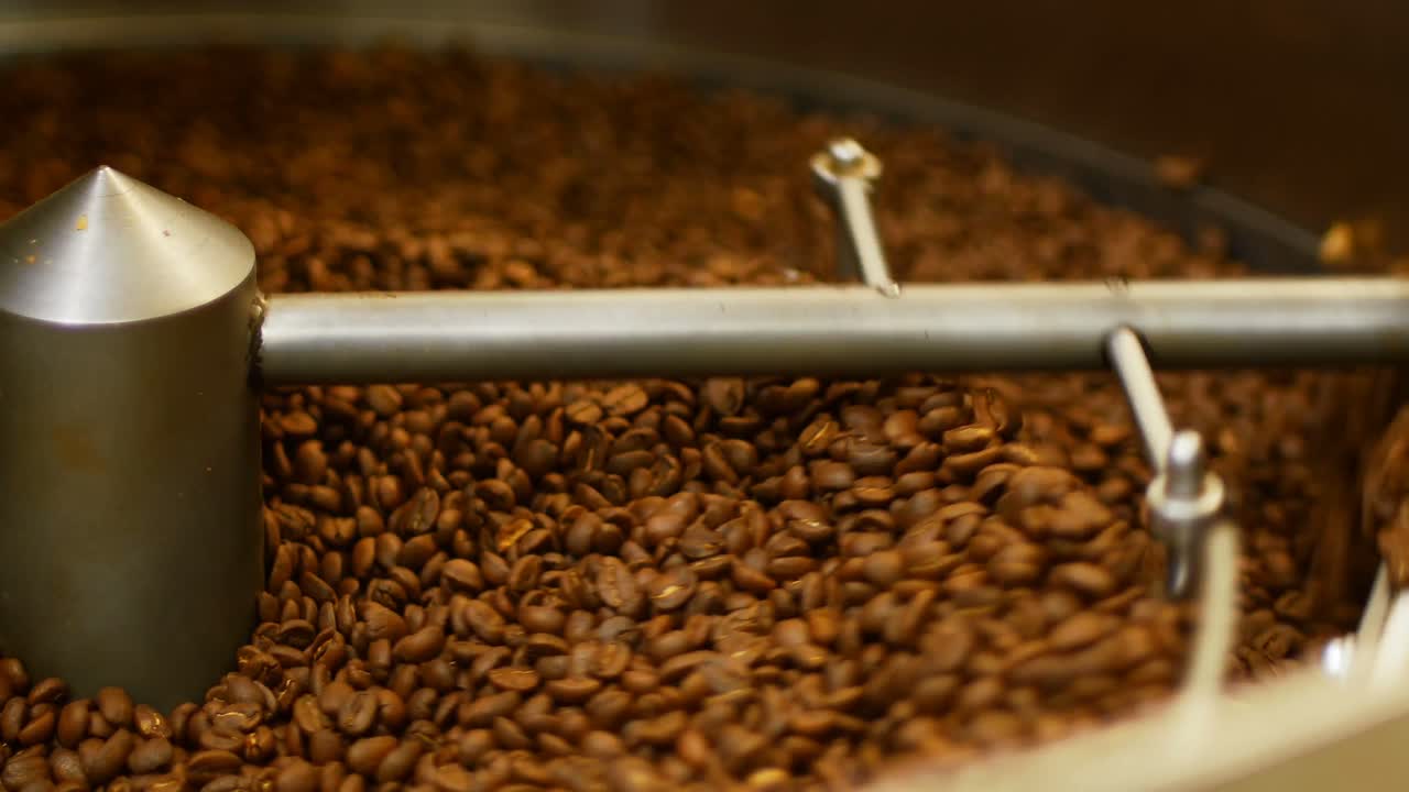 Coffee beans poured inside coffee roasting machine