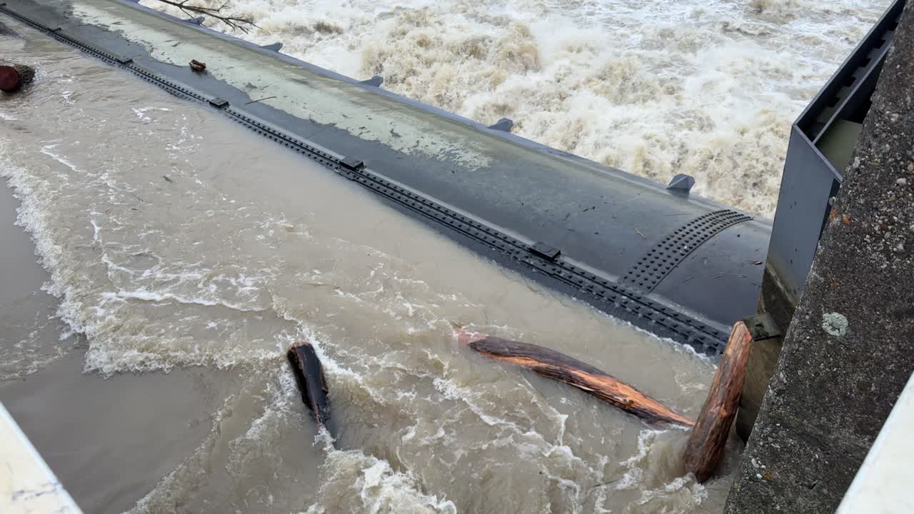 River Donau near peak level, during flood in bavaria, barrage bergheim near ingolstadt with flotsam