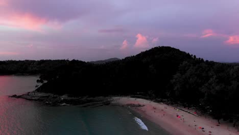 Surin-beach,-Phuket-during-Golden-Hour-Pan-Left-into-Andaman-Sea,-Establish-Shot,-Thailand,-Southeast-Asia,-4K-Droneshot