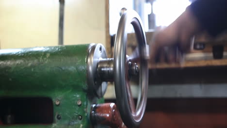 experienced operator technician machinist working intently on a large industry in metal factory workshop with large machines