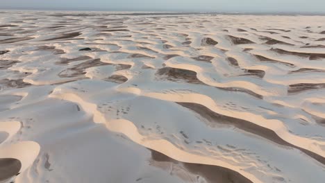 endless sand dunes of lencois maranhenses under soft lighting, aerial shot