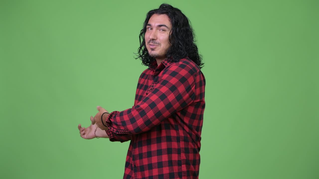 Handsome hipster man presenting something