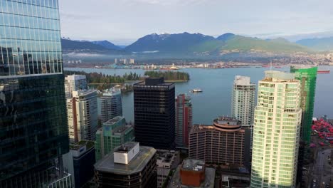 sunset view of stanley park from coal harbour in downtown vancouver, british columbia, canada