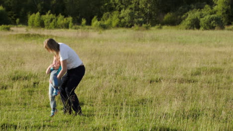 young mother playing with her son outdoor