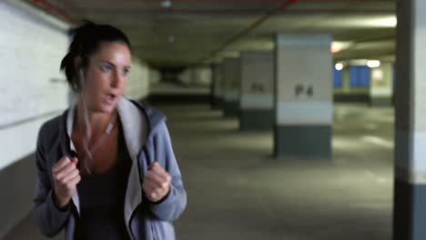 woman practicing boxing exercise at underground car parking lot 4k