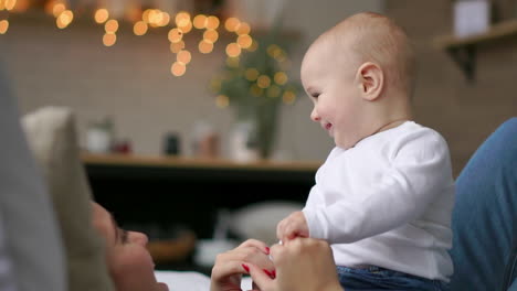 the best moments from life, a loving happy young mother hugs a nursing son, on a snow-white blanket, on a white background. concept of love, family, and happiness concept: children, kids, baby, babies