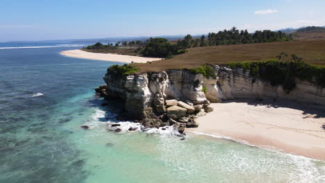 limestone cliffs with white sand beach at pantai watu bella in west sumba, east nusa tenggara, indonesia