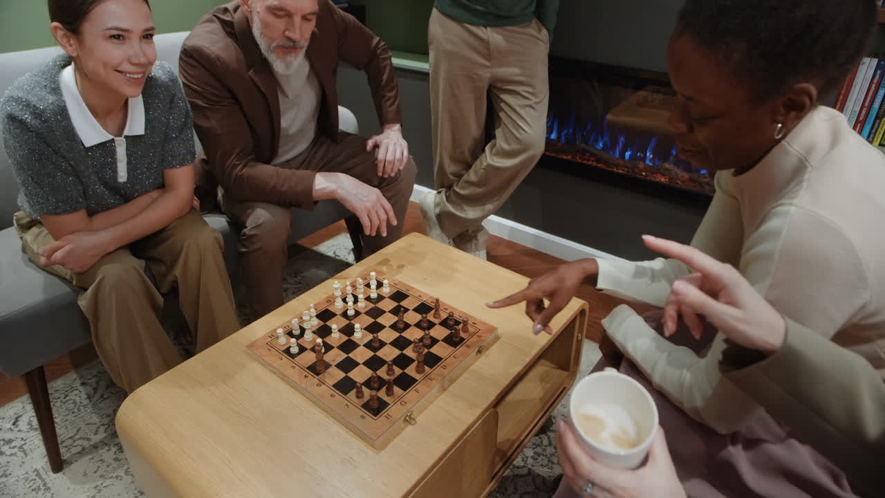 Diverse group of friends playing chess in a cozy living room