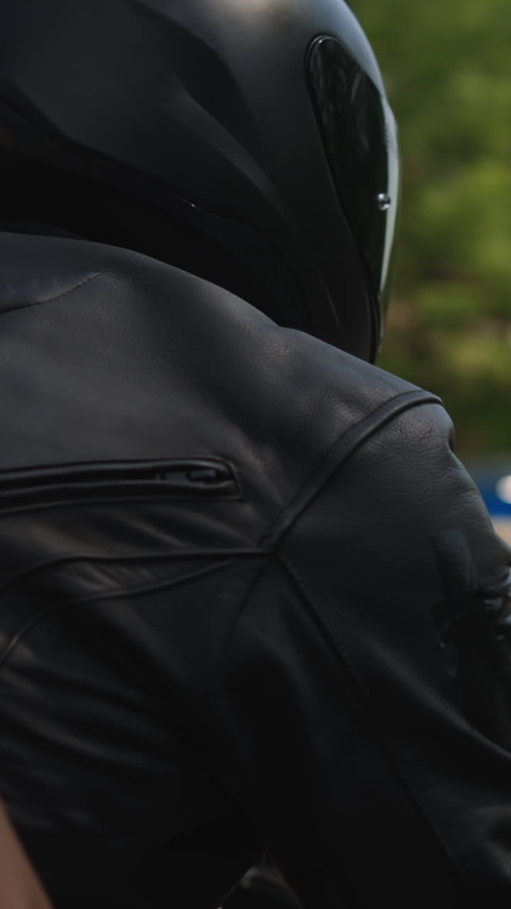 Young slim woman with bare waist sits hugging man from back on contemporary motorcycle riding along large city street on sunny spring day slow motion