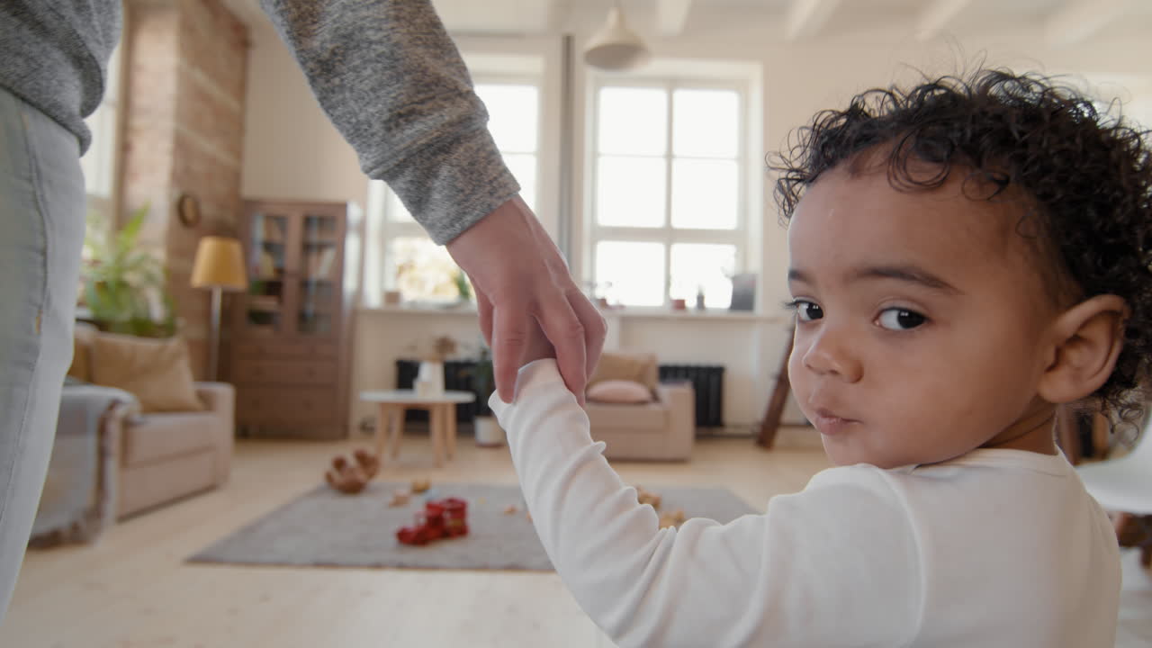 Close Up of Cute Toddler Walking with Mother at Home